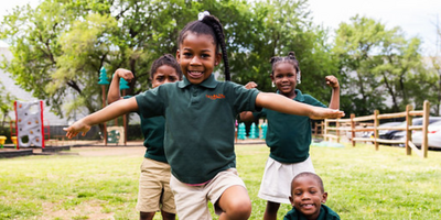 students standing on a green field