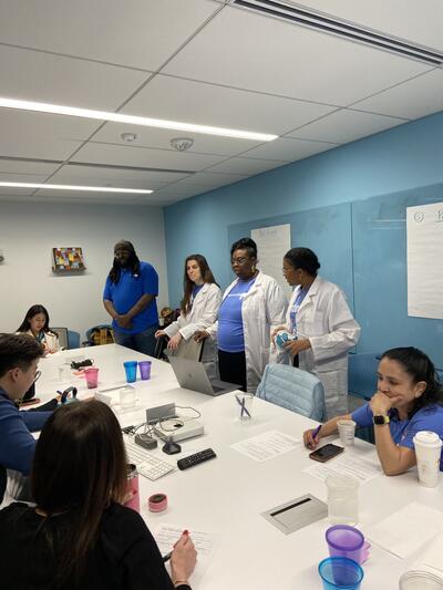 image of people standing around a table
