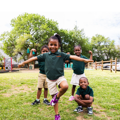 students standing on a green field